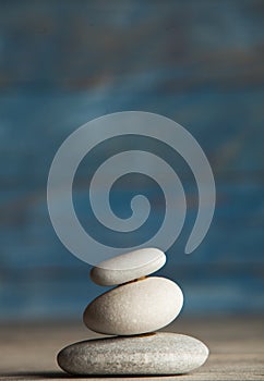 Zen sculpture. Harmony and balance, cairn, poise stones on wooden table