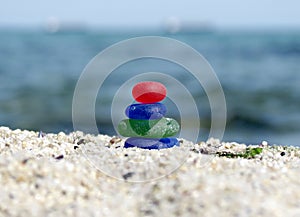 Zen sea glass stack sculpture near the sea. Harmony, balance and simplicity concept. Beach walk, beach seaglass cairn