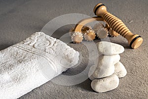 Zen spa composition, stacked white stones, massage tools and towels