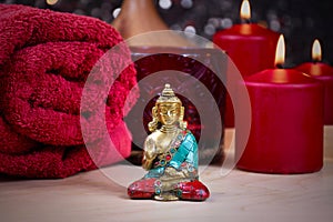 Zen spa still life with a buddha statue, red towel and candle stock photo images