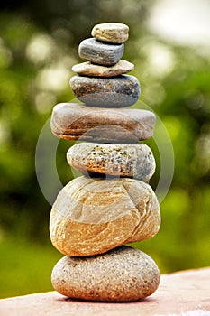 Zen spa stones stack, balance zen spa stones stacked to pyramid in the soft green background