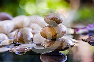 Zen stacked stones with water reflection