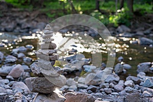 Zen stone cairn along forest stream