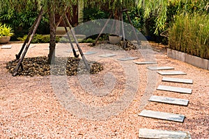 Zen stone path on gravel floor in the garden