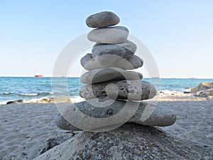 Zen stone stack near the sea. Harmony, balance and simplicity concept. Poise pebbles, zen sculpture, beach stone cairn