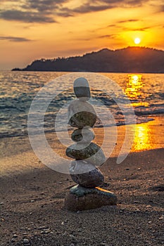 Zen stone tower on sunset background