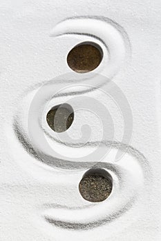 Zen stone on white sand background