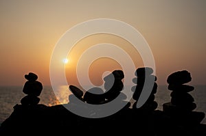 Zen stones on a background of sunset over sea