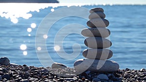 Zen stones on beach for perfect meditation. Calm zen meditate background with rock pyramid on sand beach symbolizing