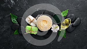 Zen stones and leaves with water drops. Spa background with spa accessories on a dark background. Top view. Free space