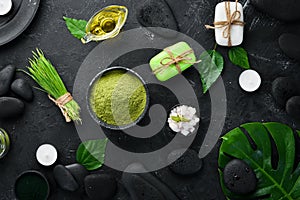 Zen stones and leaves with water drops. Spa background with spa accessories on a dark background. Top view. Free space