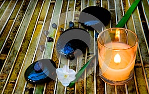 Zen stones and lit candle photo