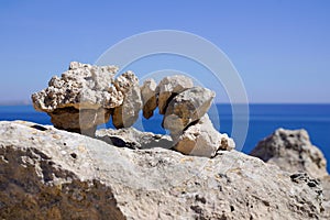 Zen stones outdoors stacked rocks balanced stone stack pyramid bridge with sea coast background water beach ocean horizon