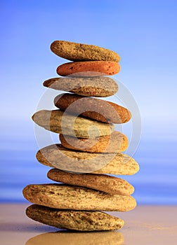 Zen stones stack on blue sky and sea background