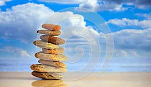 Zen stones stack on blue sky and sea background