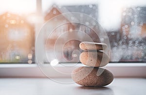 Zen Stones, Stack Pebble Rock Stones with blurry rain drops outside of window perfect for meditation. Calm Zen meditate background