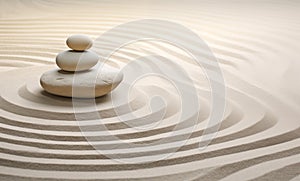 Zen stones stack on raked sand waves in a minimalist setting for balance and harmony
