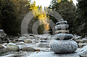 Zen stones stacked on river scene