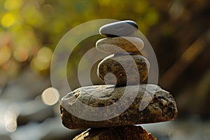 Zen stones stacked in a tranquil nature setting photo