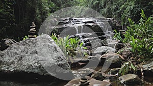 Zen stones stacked, tropical waterfall background. Meditation place for healing
