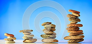 Zen stones stacks on blue sky and sea background