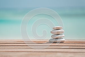 Balanced several Zen stones on blurred beautiful the beach background