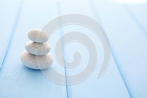 Zen stones wooden table. Pile planar stones on the old wooden rustic table.