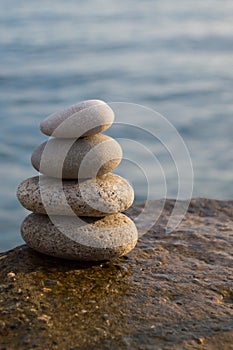 Zen style stones by the ocean. Tower of pebbles