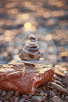 Zen Tower on Beach in Shape of Xmas Tree isolated on christmas sparkle bokeh background