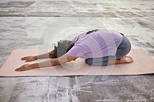 Zen yoga workout, stretching body with wellness floor exercise on mat and spiritual Indian woman in childs pose. Mental