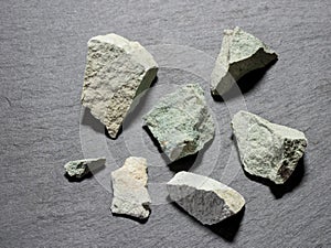 Zeolite natural raw stones on black background.