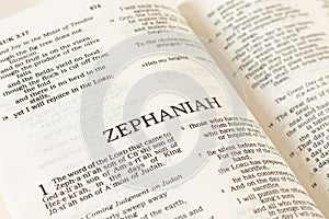 Zephaniah open Holy Bible Book close-up. Old Testament Scripture prophecy.