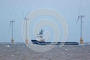 Zero carbon emission electricty production. Supply ship between wind turbines photo