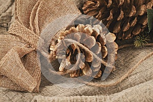 Zero waste Christmas concept. Fir cones and jute burlap decor, natural materials. Holiday concept