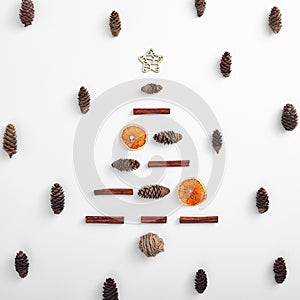 Zero waste christmas tree shape made from natural classic xmas decoration. Square composition, flat lay. Dried orange, twine clew