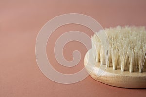 Zero waste concept. Bath brush made of bamboo isolated over brownm warm background, copy space. No plastic.