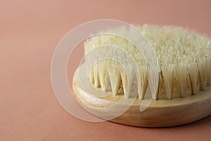 Zero waste concept. Bath brush made of bamboo isolated over brownm warm background, copy space. No plastic.