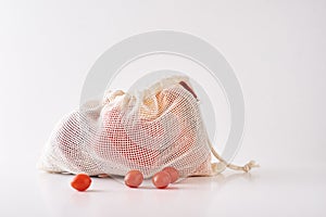 Zero waste concept. Fresh organic vegetables in textile bag on a white background