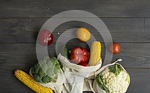 Zero waste concept. Pepper, tomato, corn, cucumber, broccoli, cauliflower in reusable shopping eco friendly cotton