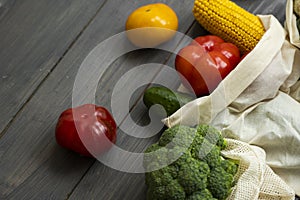 Zero waste concept. Pepper, tomato, corn, cucumber, broccoli, cauliflower in reusable shopping eco friendly cotton