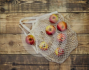 Zero waste concept, reusable mesh shopping bags.Eco-bag made of natural cotton fabric.Ripe apples in a shopping bag