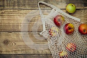 Zero waste concept, reusable mesh shopping bags.Eco-bag made of natural cotton fabric.Ripe apples in a shopping bag