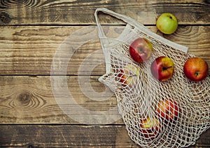 Zero waste concept, reusable mesh shopping bags.Eco-bag made of natural cotton fabric.Ripe apples in a shopping bag
