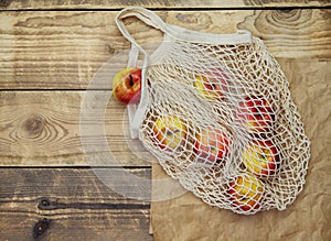 Zero waste concept, reusable mesh shopping bags.Eco-bag made of natural cotton fabric on a wooden background