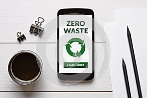 Zero waste concept on smart phone screen with office objects photo