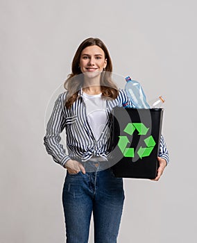 Zero Waste Concept. Young Smiling Female Holding Container With Empty Plastic Bottles