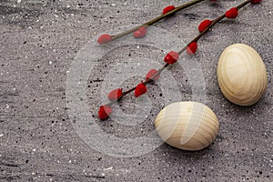 Zero waste Easter concept. Wooden egg, satin ribbon, red willow seals. No plastic, eco trend. Gray concrete background