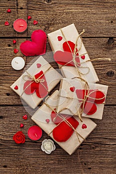 Zero waste gift concept. Valentine Day or Wedding eco friendly packaging. Festive boxes in craft paper with red felt hearts.