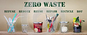 Zero Waste management, illustrated in 6 jars with text Refuse, reduce, recycle, repair, reuse, rot on cardboard background