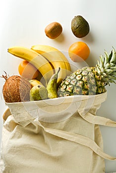 Zero waste and plastic free concept. Grocery shopping with eco bag over white background. Flat lay, top view. Copy space